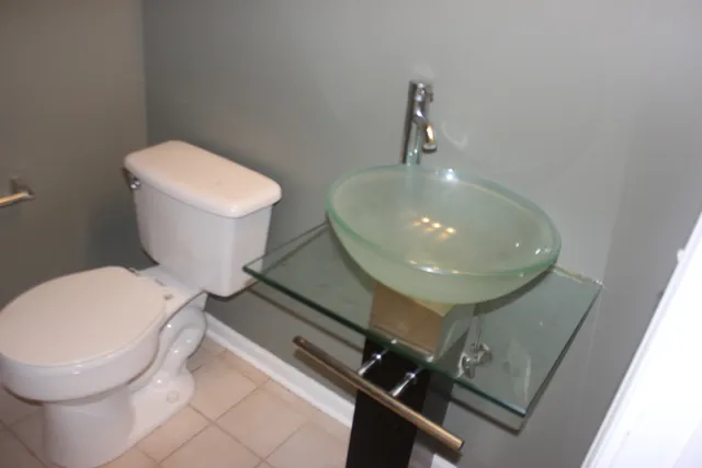 a bathroom with a toilet and a mirror