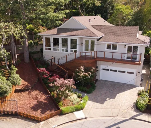 a front view of a house with a yard and a garden