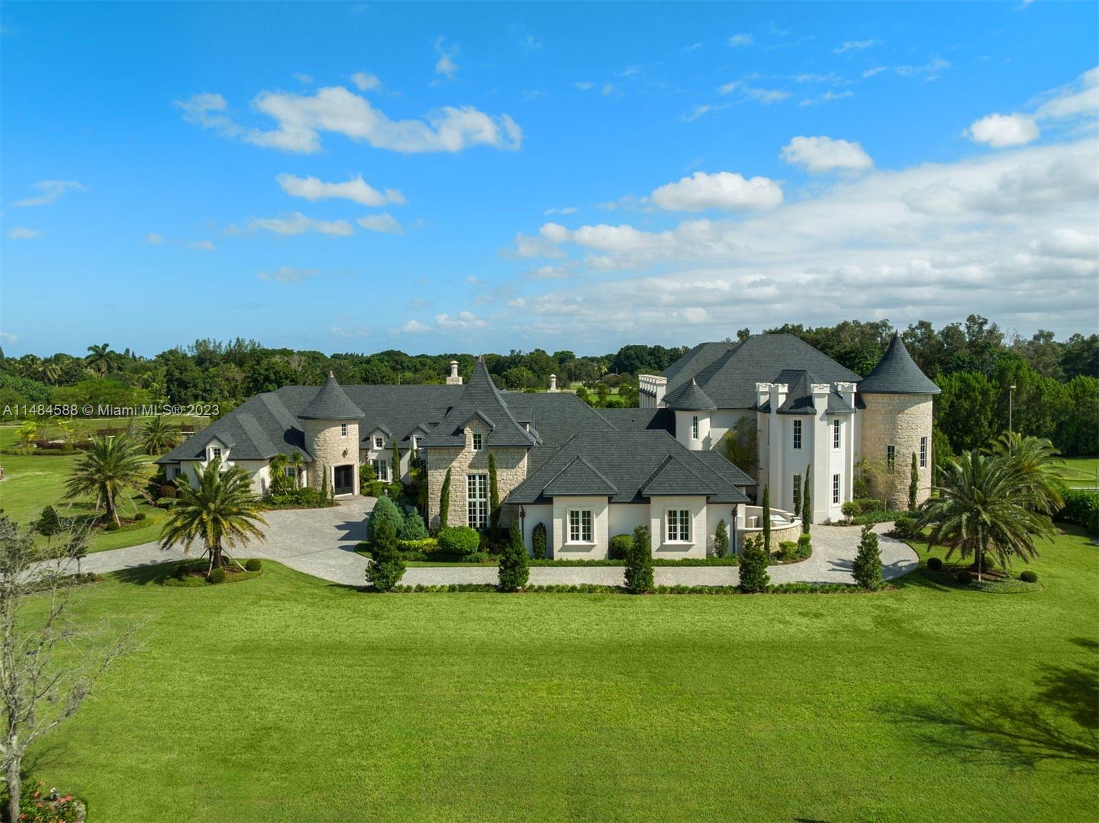 6232 Hancock Road Southwest Ranches, FL 33330 - Photo 2 of 33 a view of a big house with a big yard and large trees