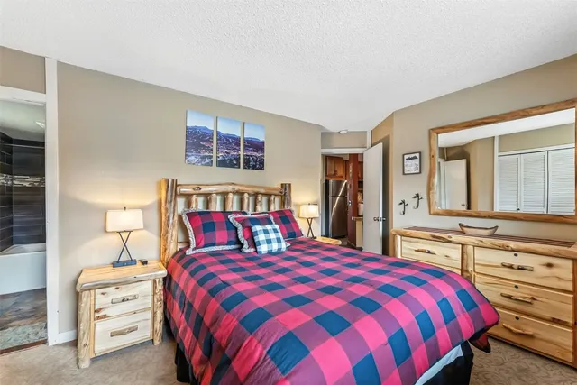 a bedroom with a bed and a television