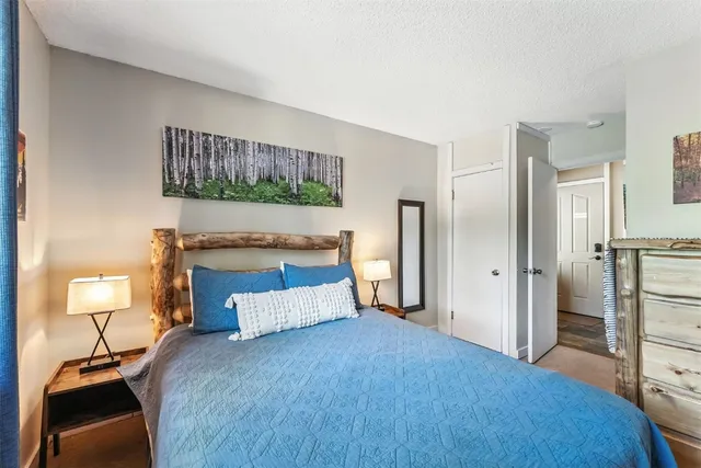 a bedroom with a bed and a lamp