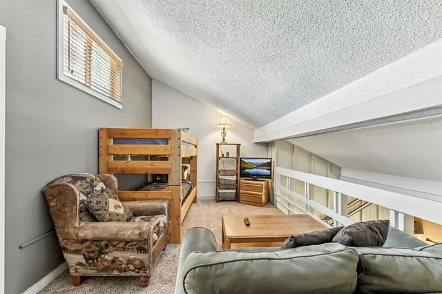 a living room with furniture a ceiling fan and a window