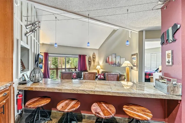 a kitchen with stainless steel appliances granite countertop a sink and a large mirror