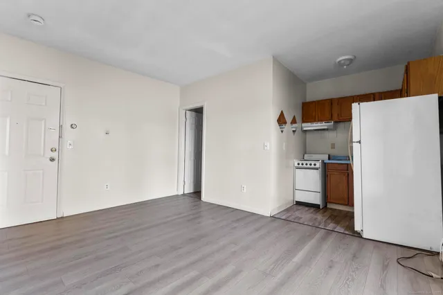 a view of a kitchen with wooden floor and electronic appliances