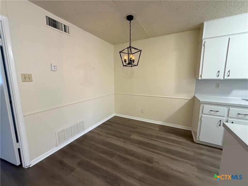2902 Lake Road, Unit 7 Killeen, TX 76543 - Photo 3 of 5 a view of a kitchen with wooden floor and cabinets