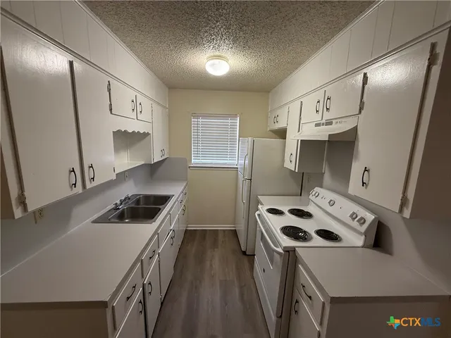 a kitchen that has a sink and a stove