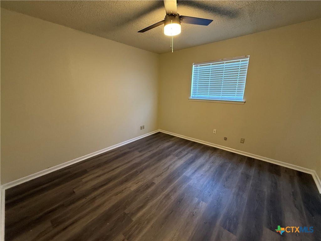 2902 Lake Road, Unit 7 Killeen, TX 76543 - Photo 5 of 5 a view of an empty room with wooden floor and a window