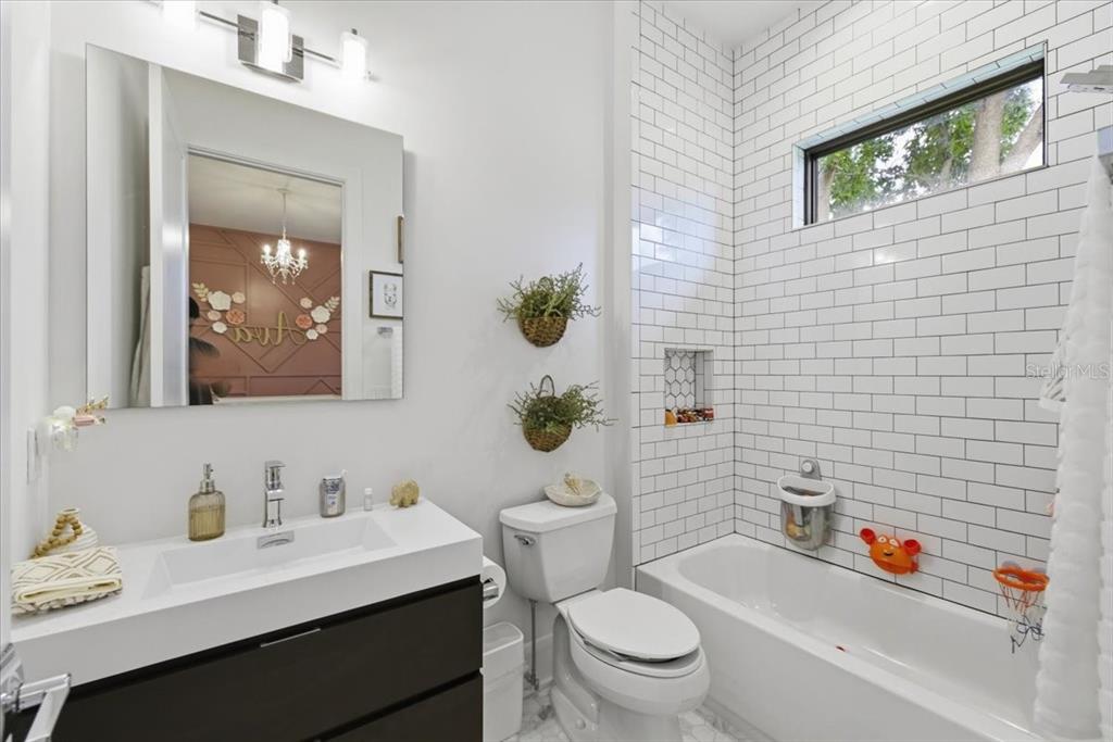 2829 Coastal Range Way Lutz, FL 33559 - Photo 50 of 64 a bathroom with a sink a toilet and shower curtain