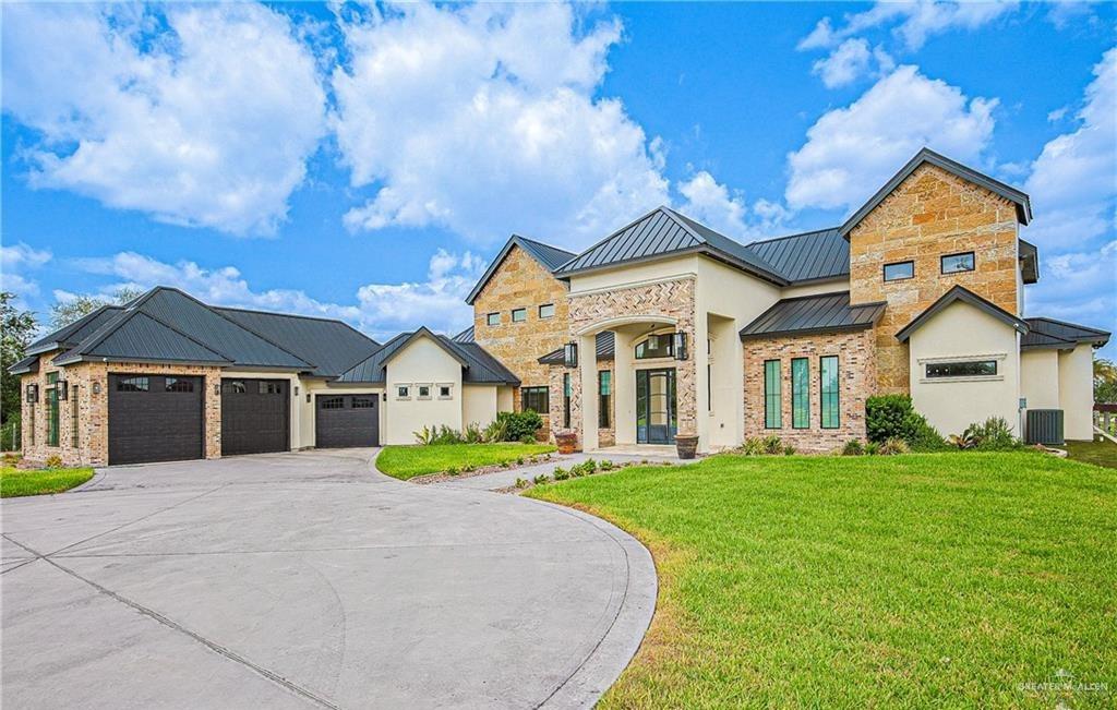 4835 Bryan Road Palmhurst, TX 78573 - Photo 1 of 45 a front view of a house with a yard and trees