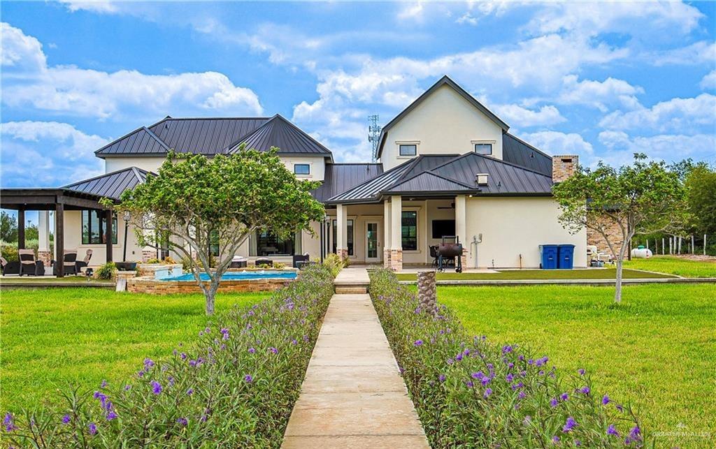 4835 Bryan Road Palmhurst, TX 78573 - Photo 39 of 45 a front view of a house with swimming pool having outdoor seating
