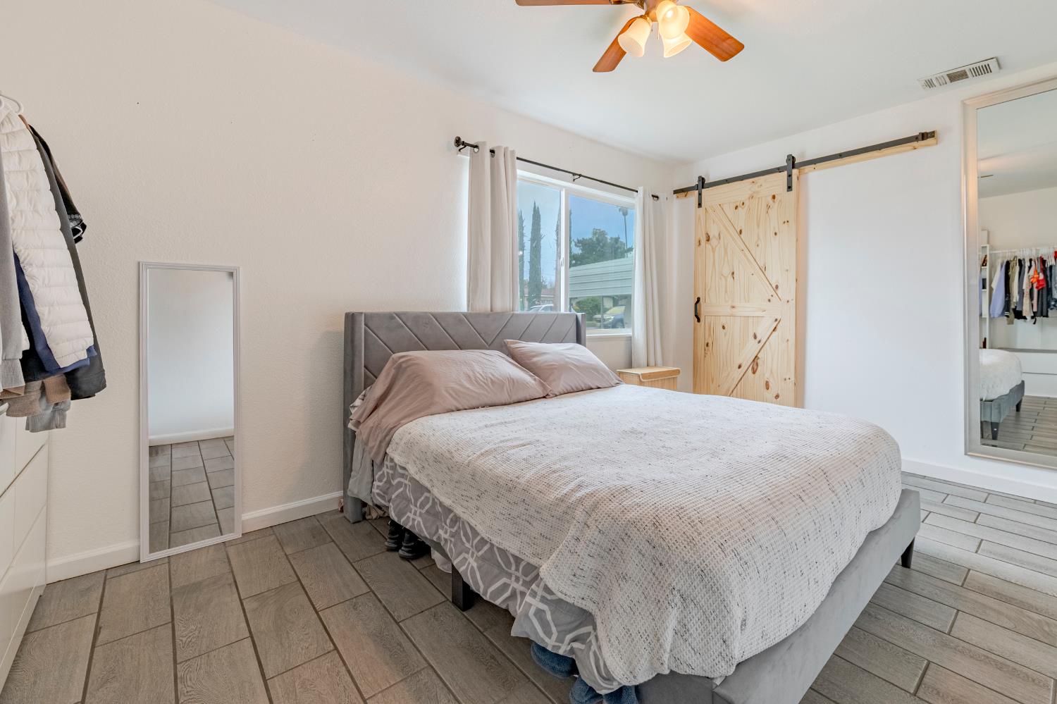 1595 East 26th Street Merced, CA 95340 - Photo 23 of 34 a bedroom with a bed and a window
