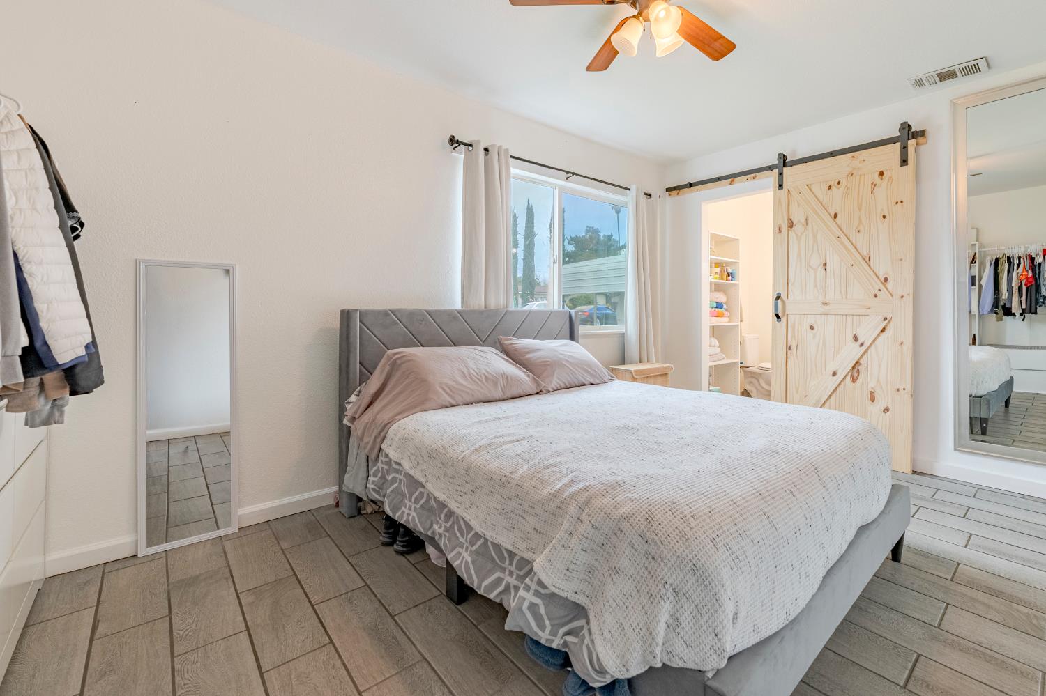 1595 East 26th Street Merced, CA 95340 - Photo 24 of 34 a large bed sitting in a bedroom next to a window