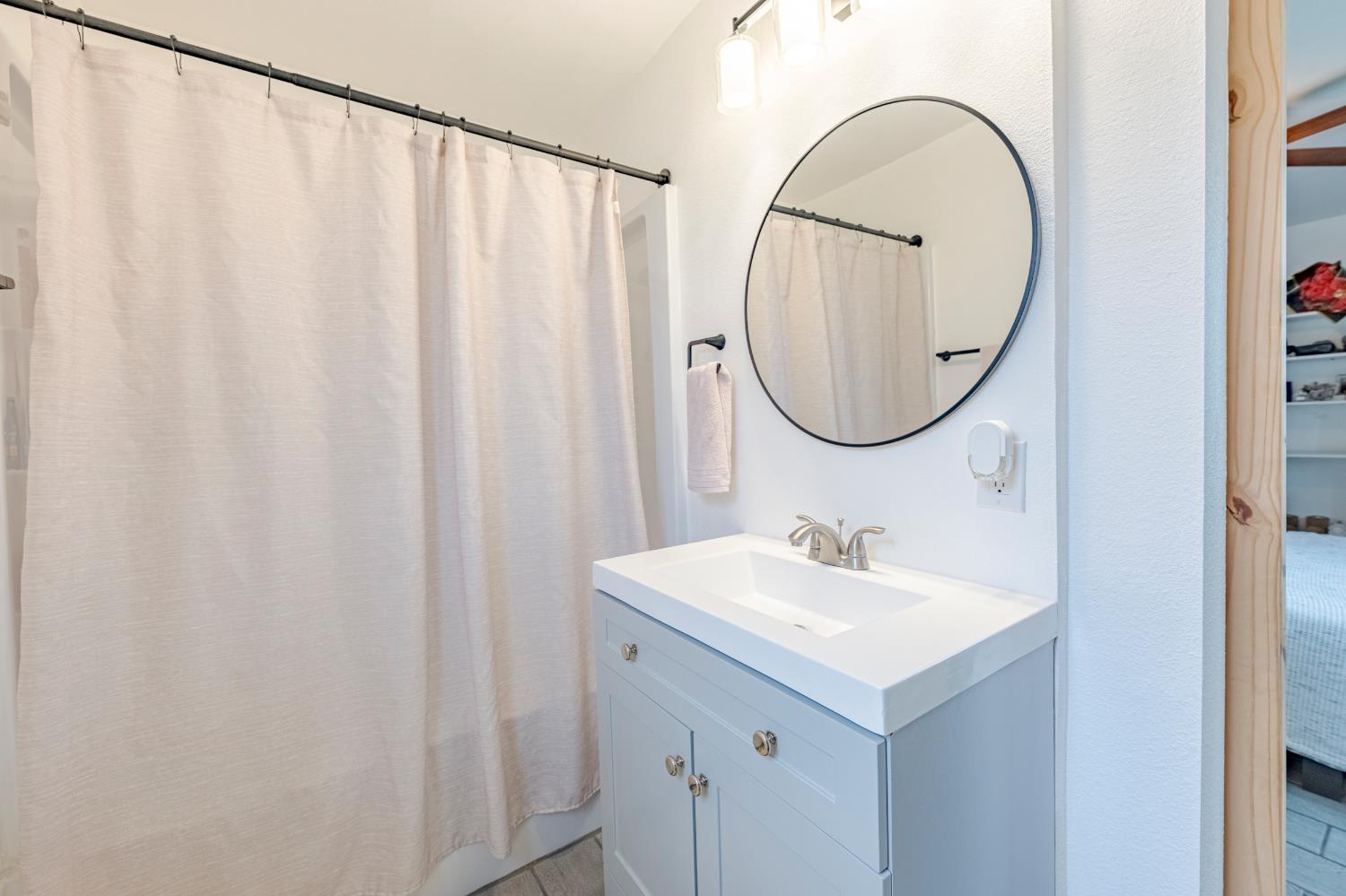 1595 East 26th Street Merced, CA 95340 - Photo 25 of 34 a bathroom with a sink and a mirror