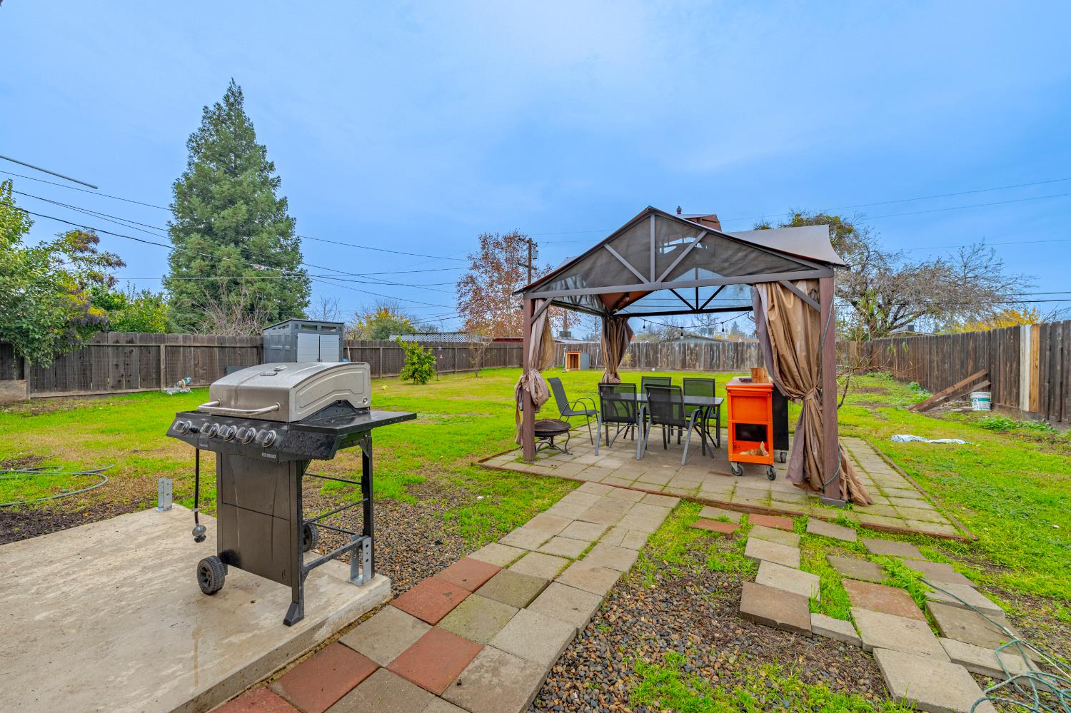 1595 East 26th Street Merced, CA 95340 - Photo 28 of 34 a view of a house with a yard porch and sitting area