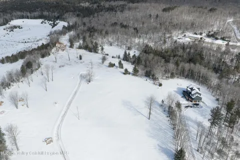 a view of a dry yard with mountains in the background
