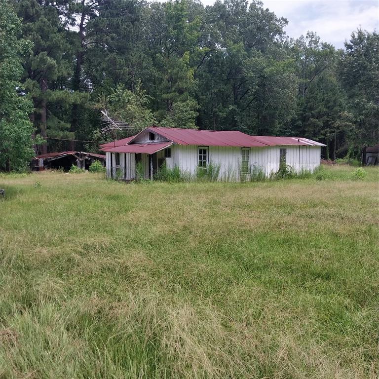 267 Pease Road Haughton, LA 71037 - Photo 15 of 18 a backyard of a house with plants and large trees