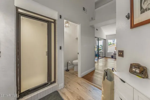 a view of a hallway and a livingroom with wooden floor
