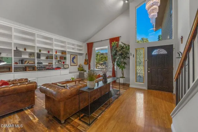 a living room with furniture and a floor to ceiling window