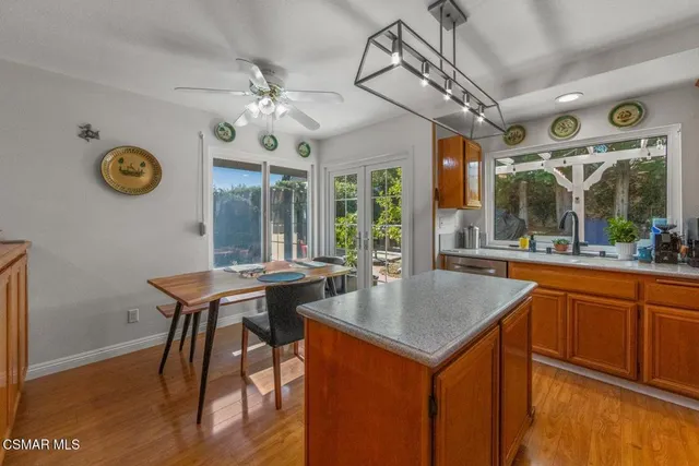 a kitchen with a table chairs and wooden floor