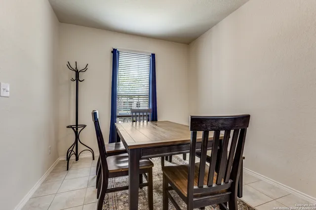 a view of a dining room with furniture and window