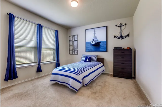 a spacious bedroom with a bed and a window