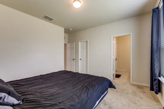 a bedroom with a bed and a dresser