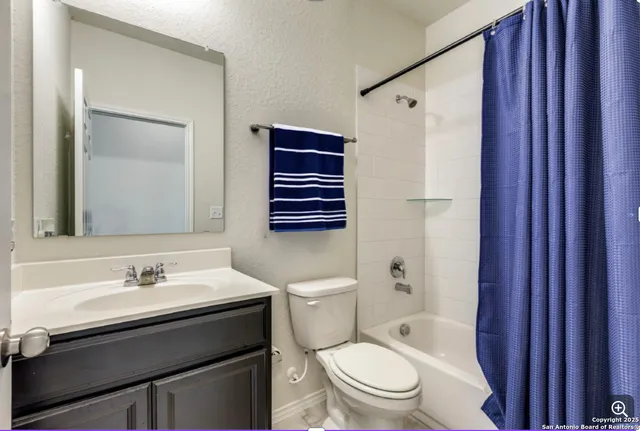 a bathroom with a sink toilet a mirror and shower