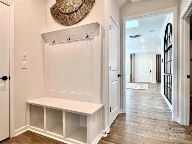a view of a hallway with wooden floor