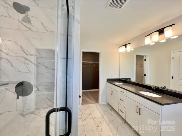 a bath room with a sink and a mirror