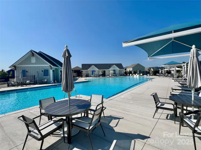 a view of house with backyard outdoor seating area and furniture