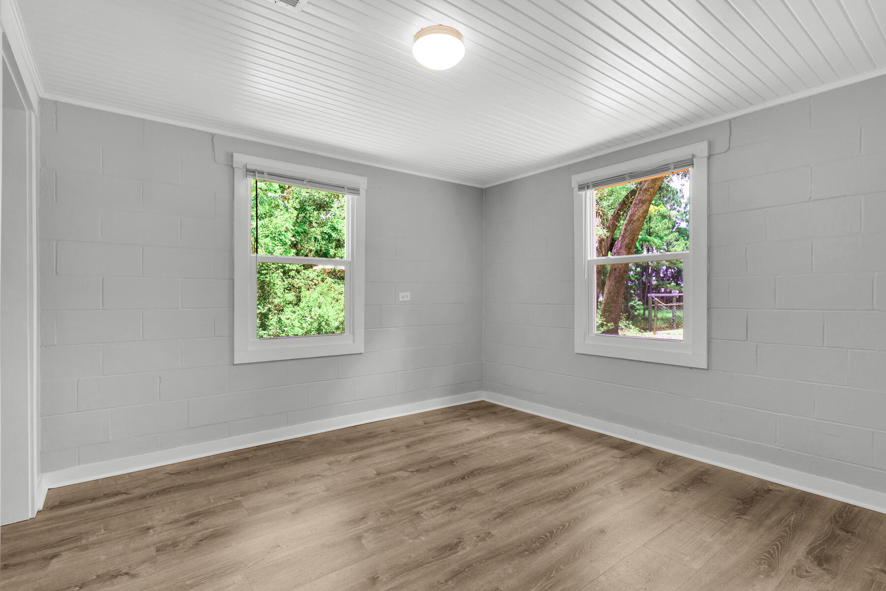 771 Alaqua Drive Freeport, FL 32439 - Photo 16 of 23 an empty room with wooden floor and windows