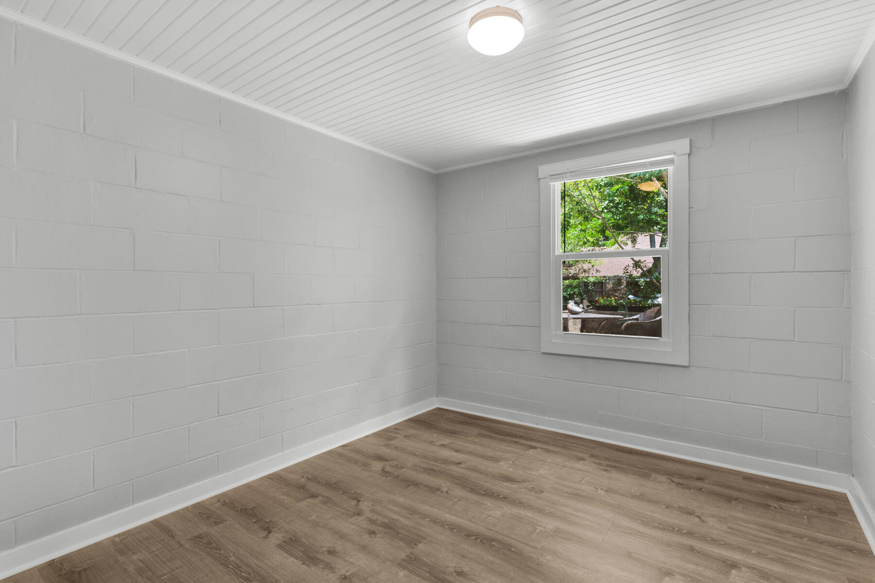 771 Alaqua Drive Freeport, FL 32439 - Photo 18 of 23 a view of an empty room with wooden floor and a window