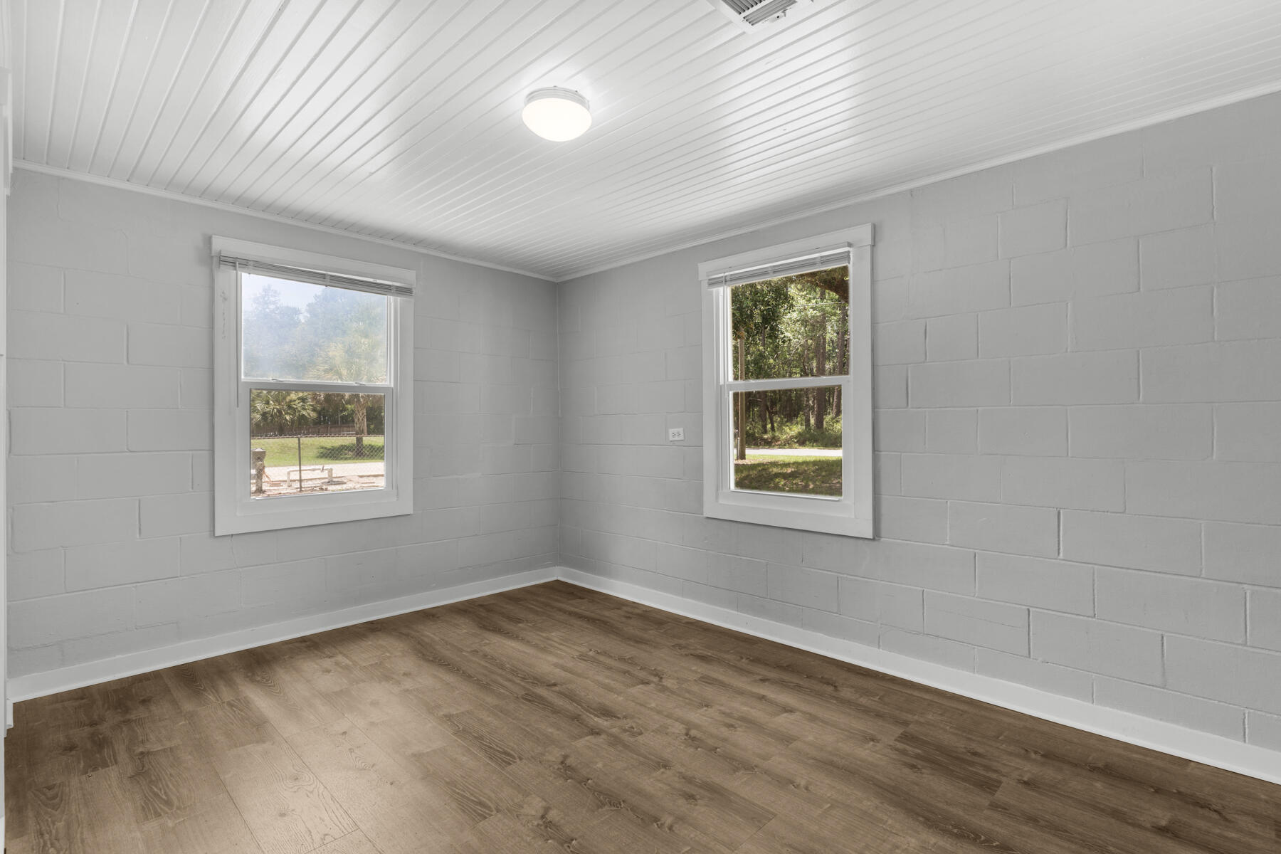 771 Alaqua Drive Freeport, FL 32439 - Photo 20 of 23 a view of an empty room with wooden floor and a window
