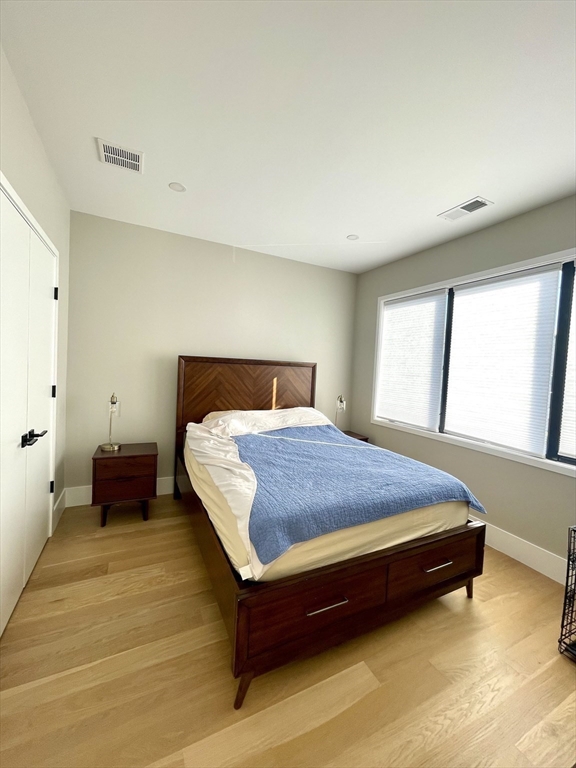 61 Allison Street, Unit 2 Newton, MA 02458 - Photo 18 of 26 a bedroom with a bed and window