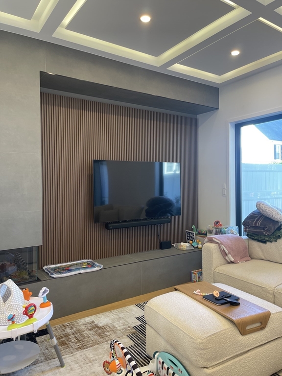 61 Allison Street, Unit 2 Newton, MA 02458 - Photo 5 of 26 a living room with a couch and a flat screen tv