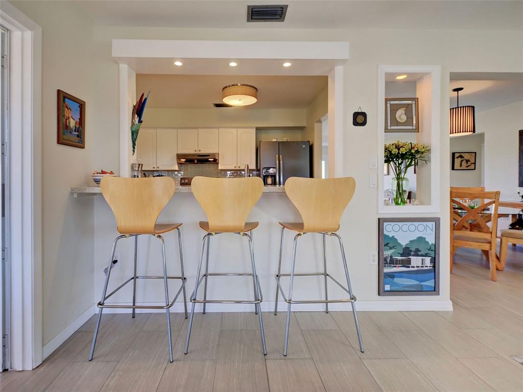 1350 Lakeside Drive Venice, FL 34293 - Photo 15 of 64 a view of a dining room with furniture and wooden floor