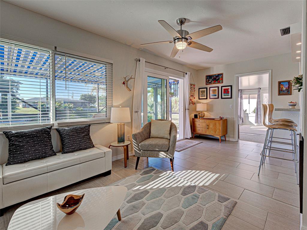 1350 Lakeside Drive Venice, FL 34293 - Photo 19 of 64 a living room with furniture and a large window with bookshelf