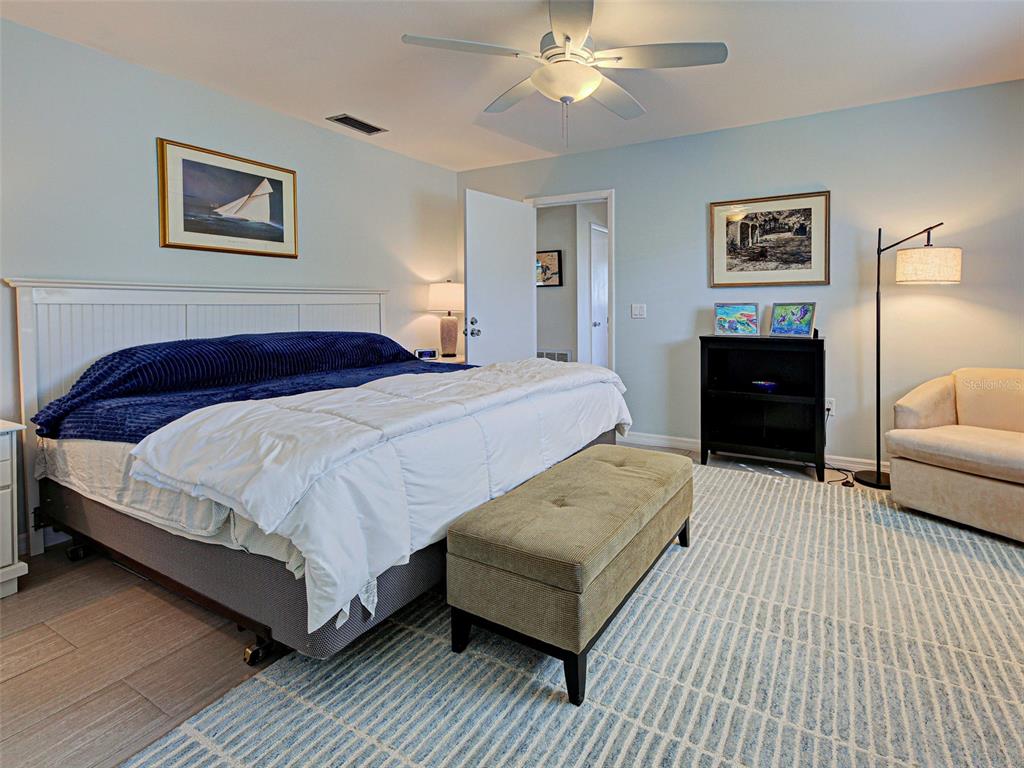 1350 Lakeside Drive Venice, FL 34293 - Photo 27 of 64 a bedroom with a bed and lamp