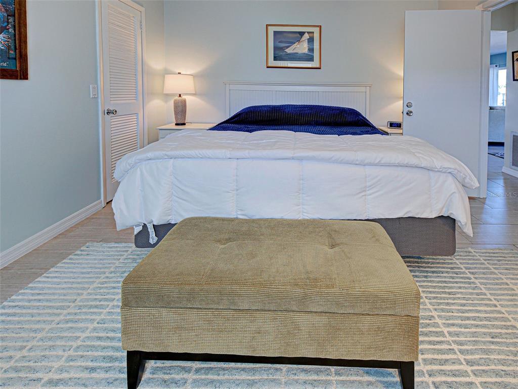 1350 Lakeside Drive Venice, FL 34293 - Photo 29 of 64 a bedroom with a bed and painting on the wall
