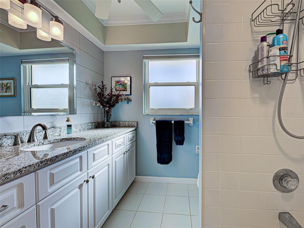 1350 Lakeside Drive Venice, FL 34293 - Photo 35 of 64 a en suite bathroom with a granite countertop sink and a mirror