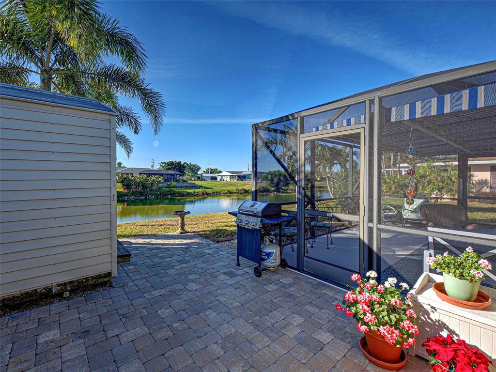 1350 Lakeside Drive Venice, FL 34293 - Photo 42 of 64 a view of a patio with a dining table and chairs potted plants
