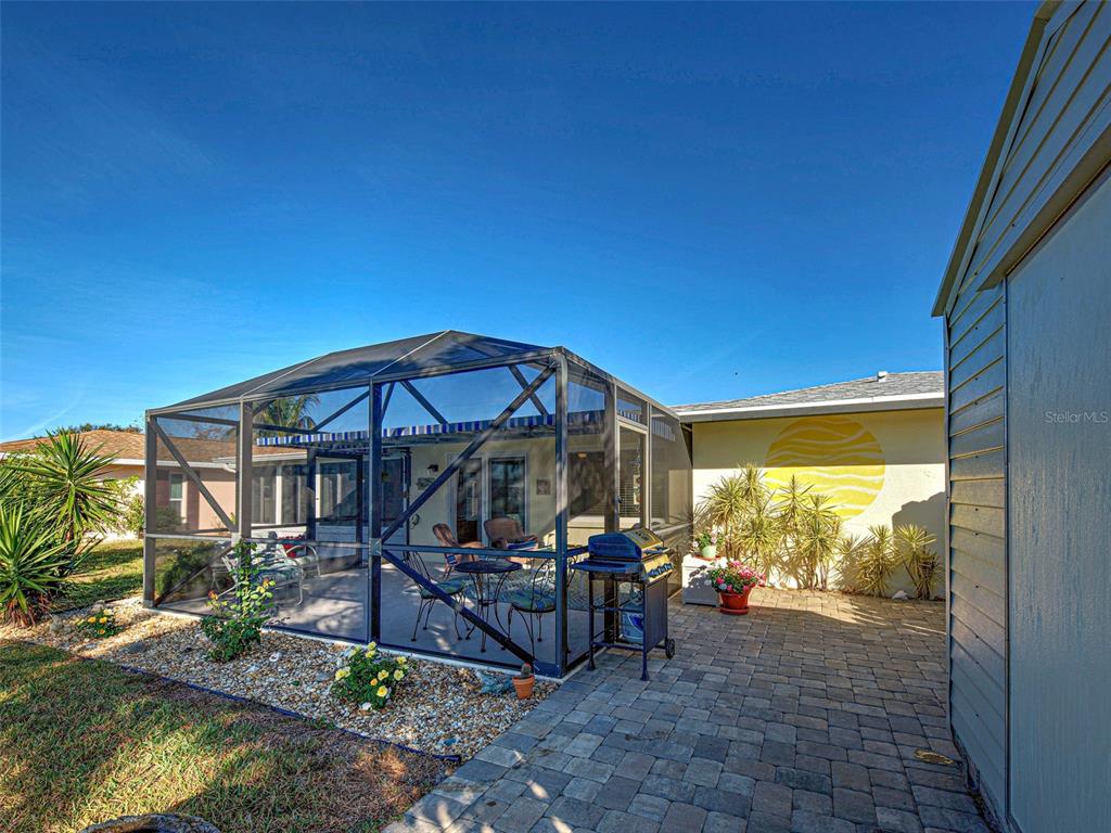 1350 Lakeside Drive Venice, FL 34293 - Photo 50 of 64 a view of a patio with table and chairs under an umbrella
