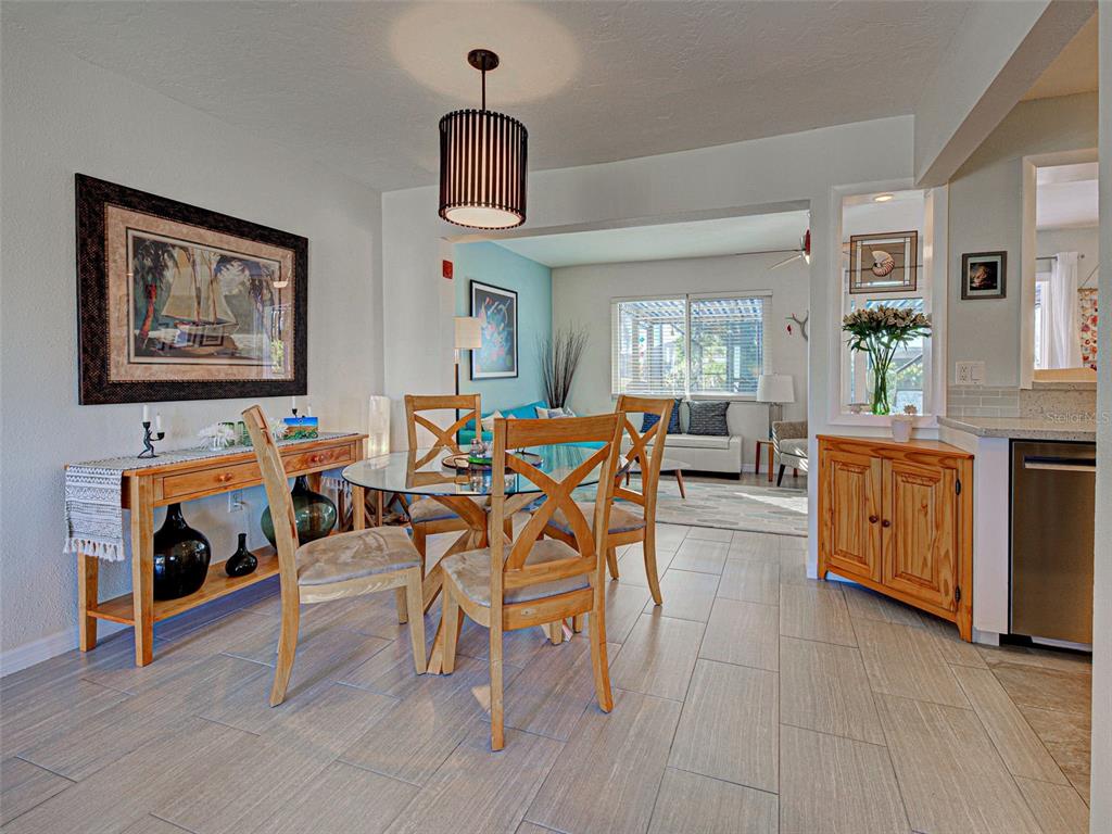 1350 Lakeside Drive Venice, FL 34293 - Photo 10 of 64 a view of a dining room with furniture window and wooden floor