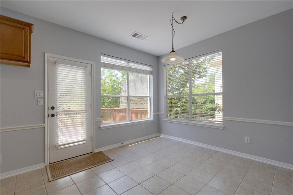 13017 Titus Court Austin, TX 78732 - Photo 15 of 26 Unfurnished dining area featuring light tile patterned floors
