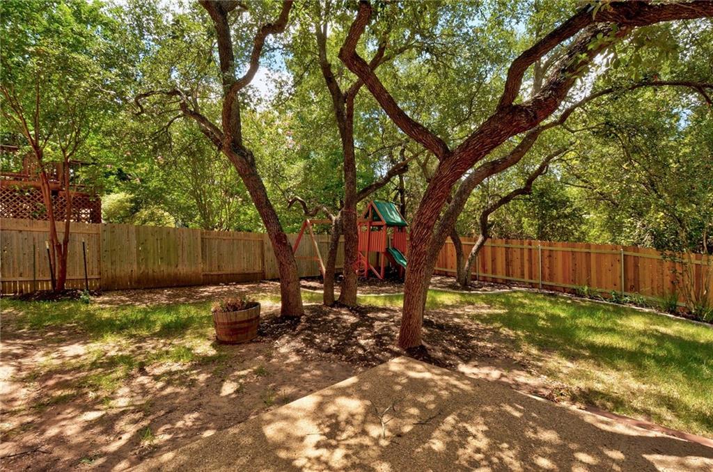 13017 Titus Court Austin, TX 78732 - Photo 23 of 26 Fenced backyard featuring a playground
