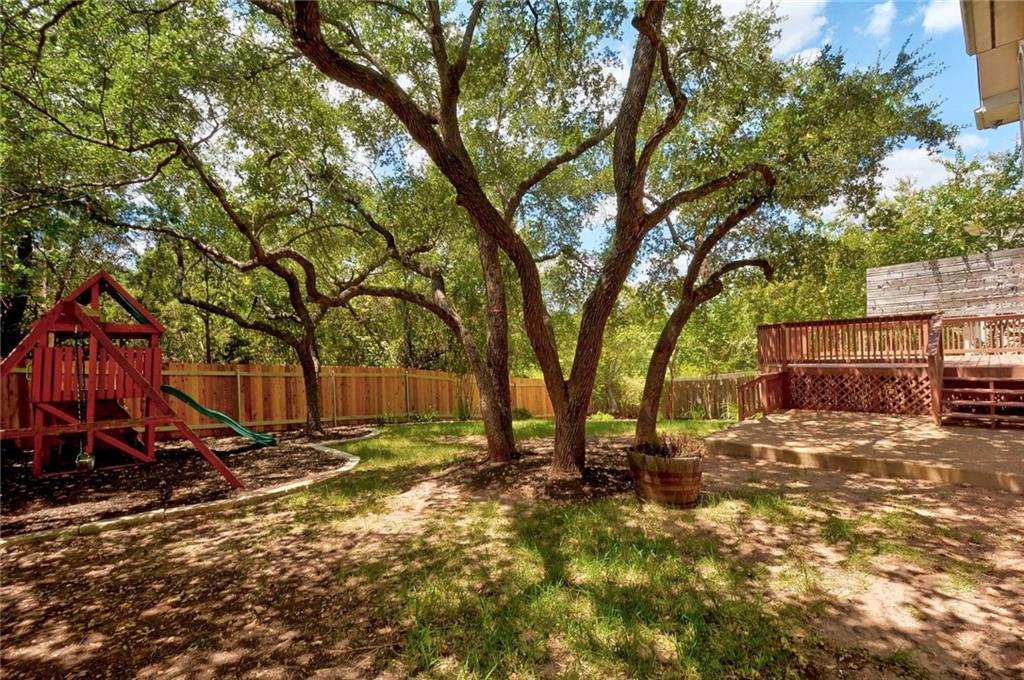 13017 Titus Court Austin, TX 78732 - Photo 24 of 26 Fenced backyard with a playground and a wooden deck