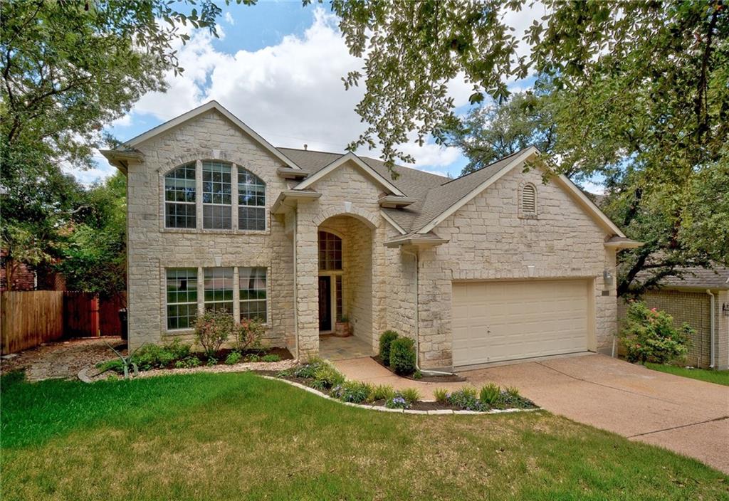13017 Titus Court Austin, TX 78732 - Photo 3 of 26 Traditional-style home featuring stone siding, concrete driveway, and a garage