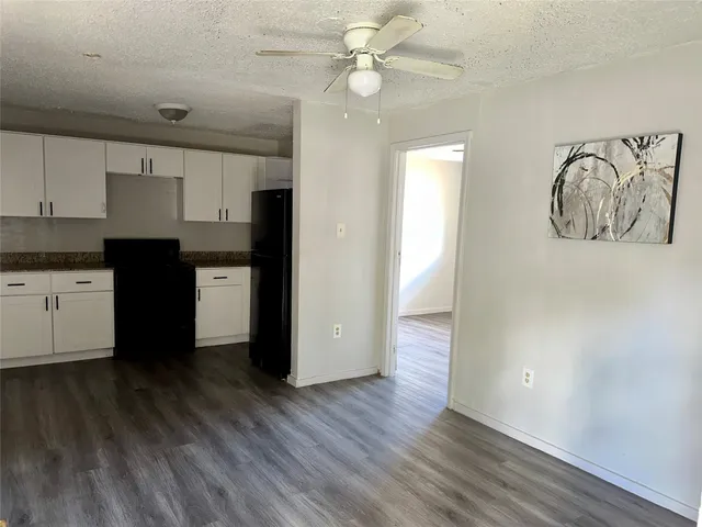 a kitchen with a refrigerator and a stove top oven