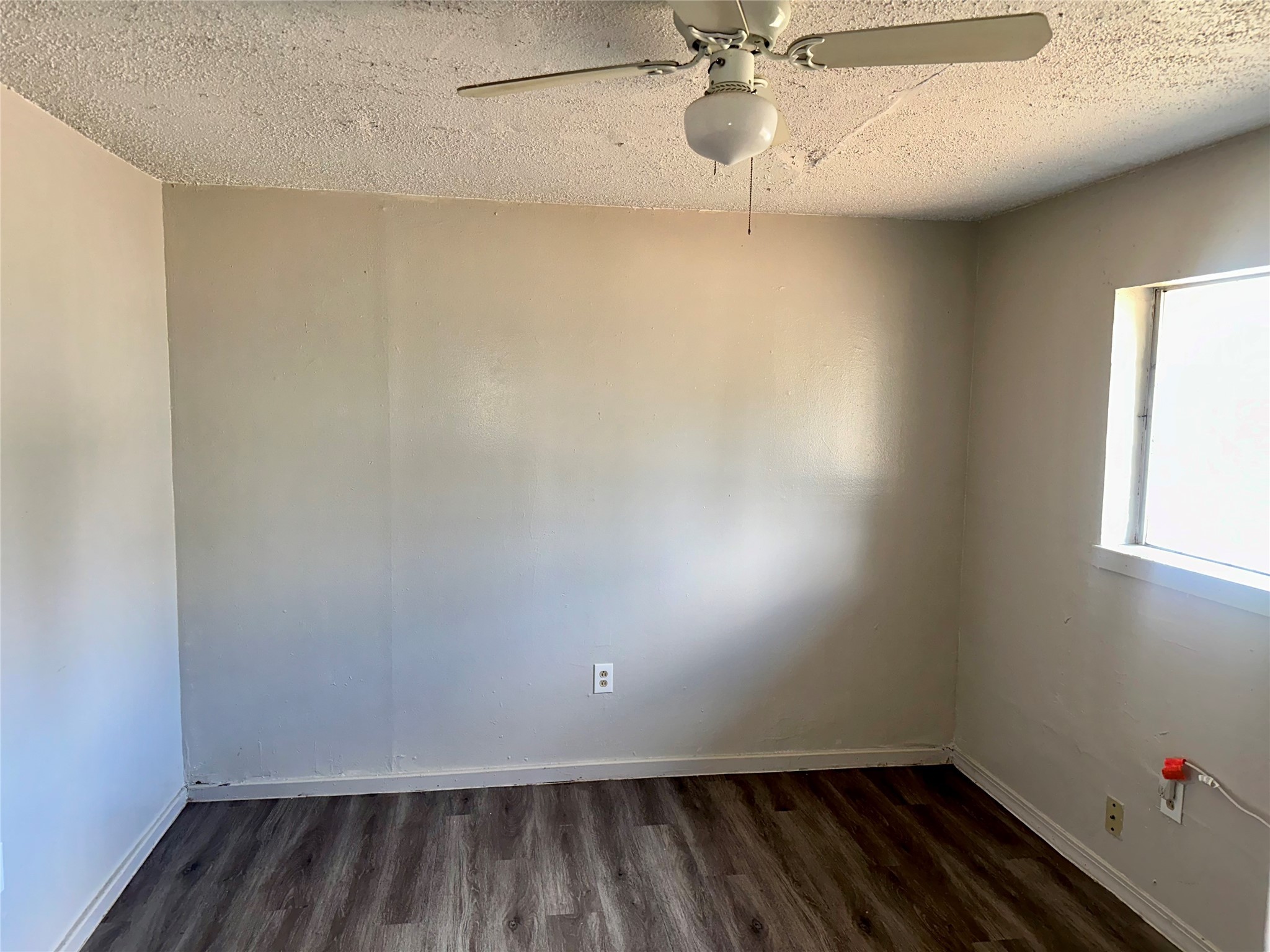 5405 Suez Street, Unit 1 Houston, TX 77020 - Photo 9 of 17 an empty room with a window and a fan
