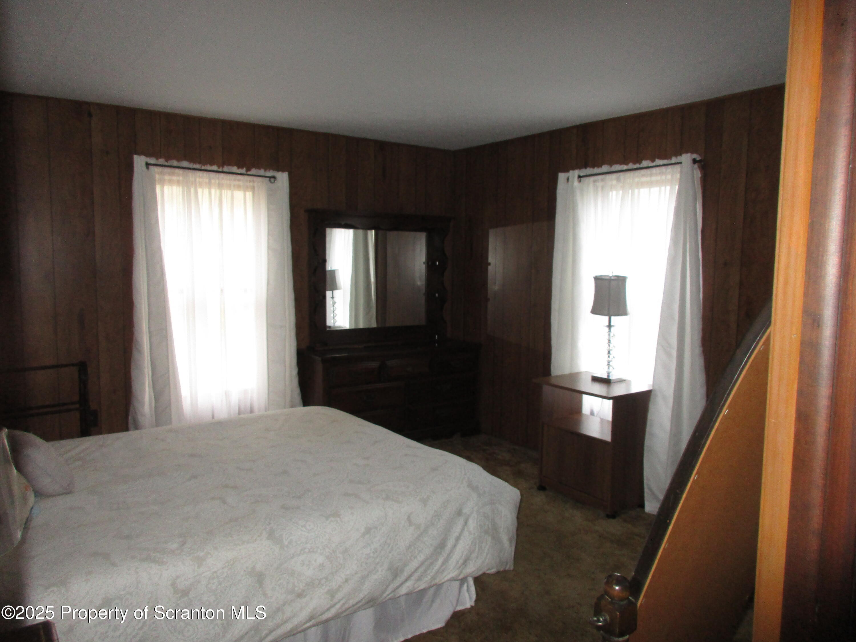 24 Oak Street Nicholson, PA 18446 - Photo 13 of 17 a bedroom with a large bed and wooden floor